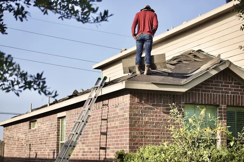 Professional roofer working on a residential roof in Shawano